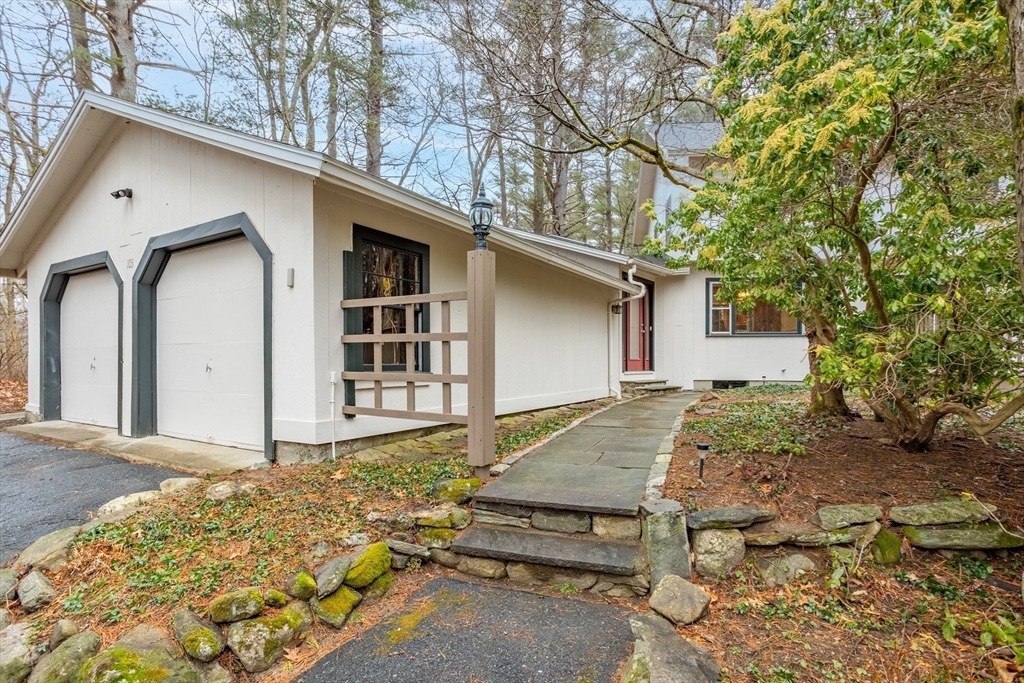 103 Newtown Road Acton, MA 01720 - Photo 30 of 42 a front view of a house with garden