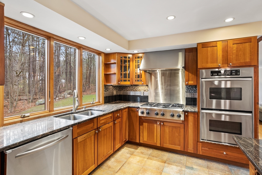 103 Newtown Road Acton, MA 01720 - Photo 3 of 42 a kitchen with stainless steel appliances granite countertop a stove and a refrigerator