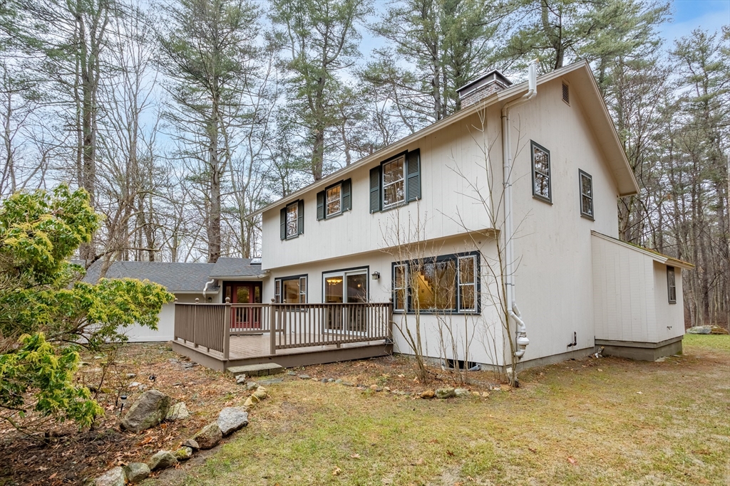 103 Newtown Road Acton, MA 01720 - Photo 32 of 42 a white house that has a tree in front of it