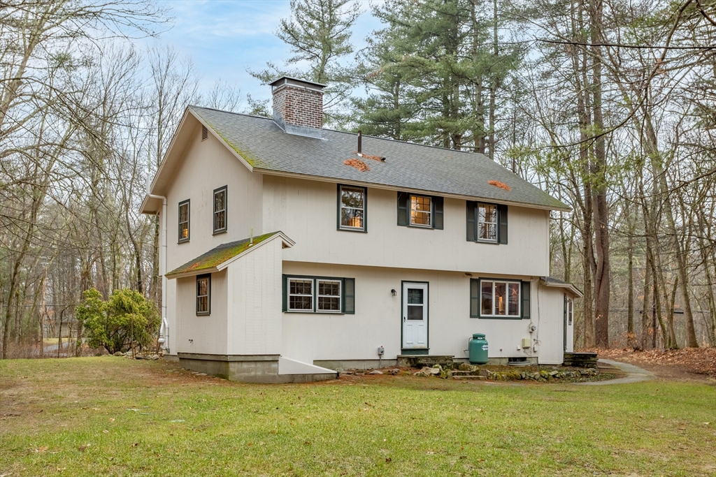 103 Newtown Road Acton, MA 01720 - Photo 34 of 42 a front view of a house with a yard