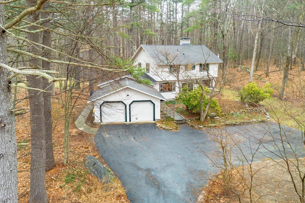 103 Newtown Road Acton, MA 01720 - Photo 36 of 42 a view of a house with a yard and potted plants