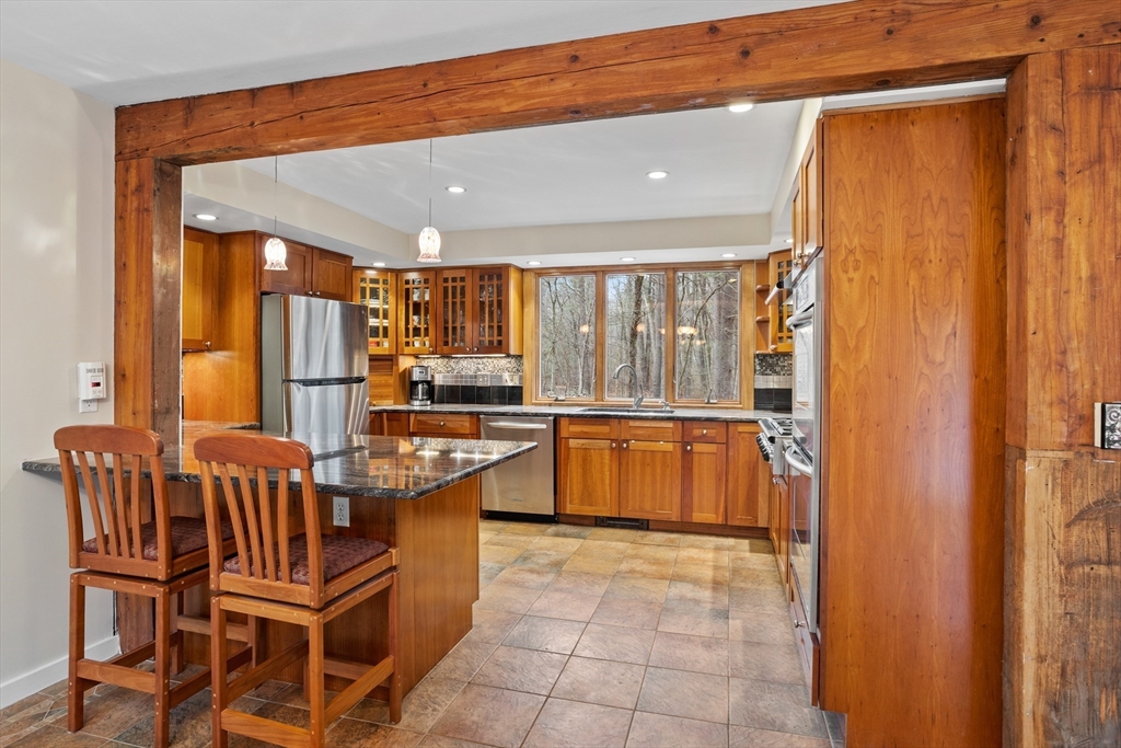 103 Newtown Road Acton, MA 01720 - Photo 4 of 42 a large kitchen with a large window and furniture