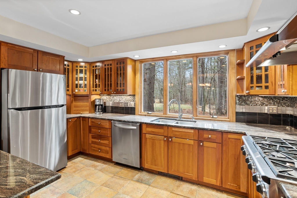 103 Newtown Road Acton, MA 01720 - Photo 5 of 42 a kitchen with stainless steel appliances granite countertop a refrigerator and a sink