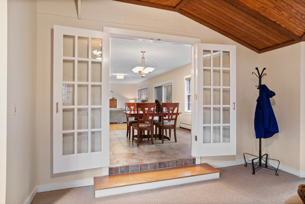103 Newtown Road Acton, MA 01720 - Photo 9 of 42 a view of a dining room with furniture and a chandelier
