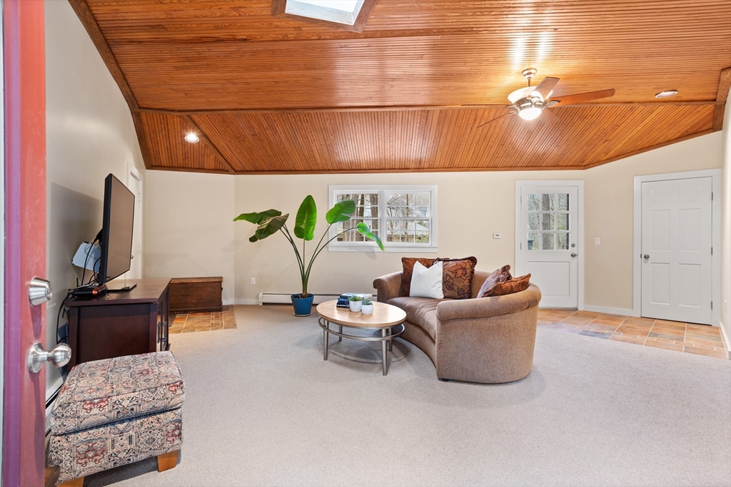 103 Newtown Road Acton, MA 01720 - Photo 10 of 42 a living room with furniture and a flat screen tv