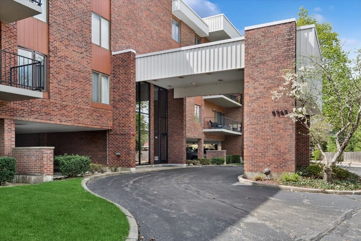 6545 Main Street, Unit 407 Downers Grove, IL 60516 - Photo 1 of 18 a front view of a house with garden