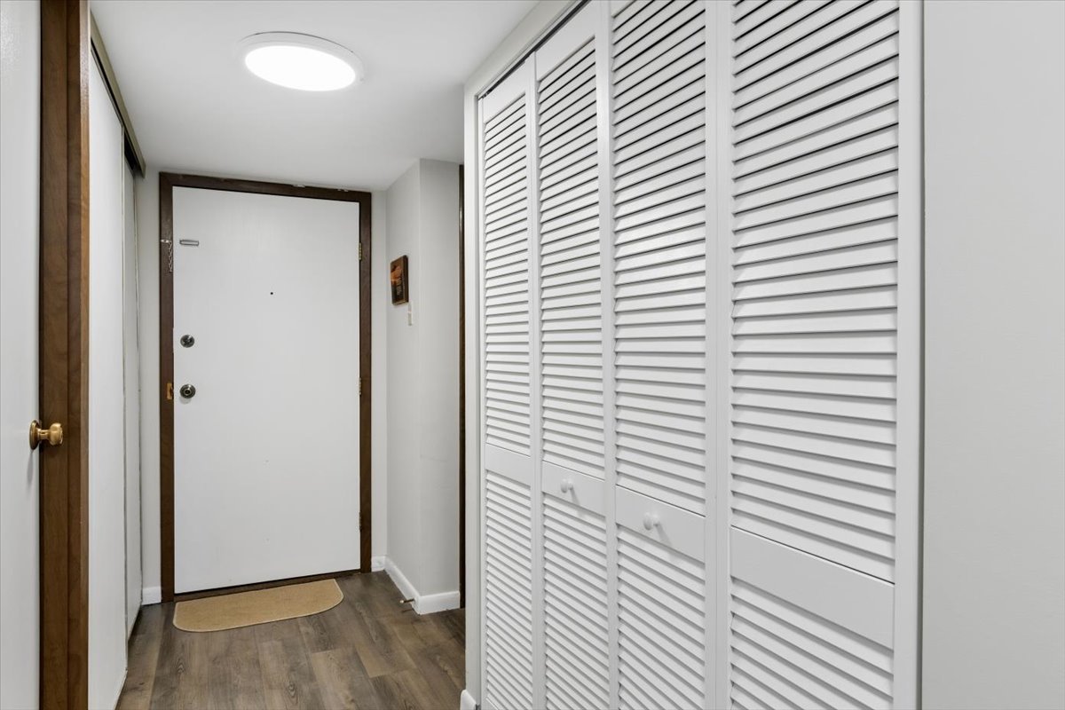 6545 Main Street, Unit 407 Downers Grove, IL 60516 - Photo 3 of 18 a view of a hallway with wooden floor