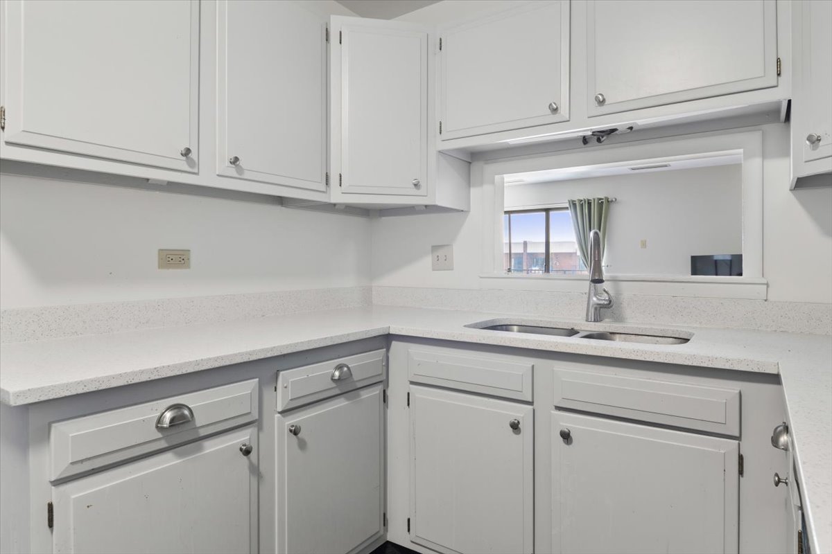 6545 Main Street, Unit 407 Downers Grove, IL 60516 - Photo 4 of 18 a kitchen with white cabinets and white appliances