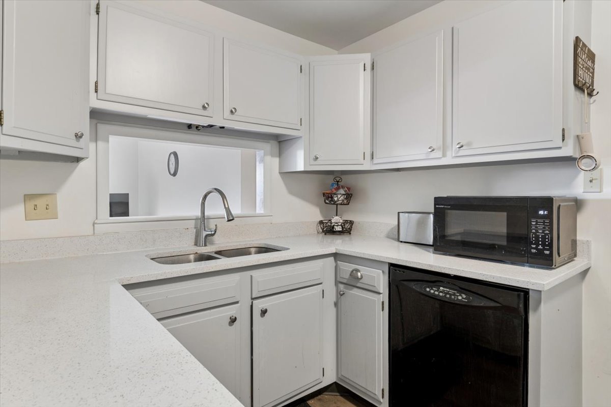 6545 Main Street, Unit 407 Downers Grove, IL 60516 - Photo 5 of 18 a kitchen with white cabinets and white appliances