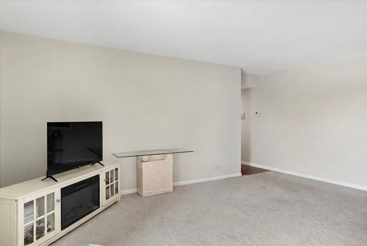 6545 Main Street, Unit 407 Downers Grove, IL 60516 - Photo 8 of 18 a living room with a flat screen tv