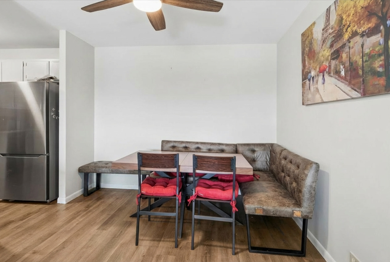6545 Main Street, Unit 407 Downers Grove, IL 60516 - Photo 9 of 18 a view of a dining room with furniture and wooden floor