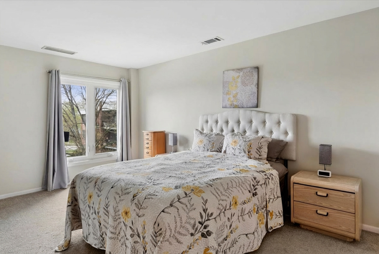 6545 Main Street, Unit 407 Downers Grove, IL 60516 - Photo 10 of 18 a bedroom with a bed and a window