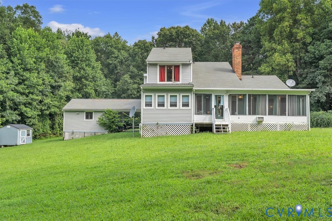 4037 Quinton Road Quinton, VA 23141 - Photo 4 of 39 Back of property with a sunroom, a lawn, a chimney