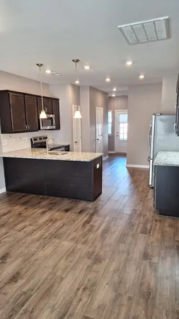 a large kitchen with kitchen island a sink stainless steel appliances and cabinets