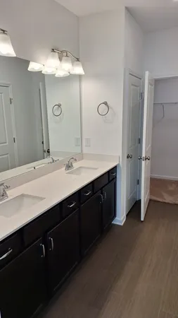 a bathroom with a double vanity sink and mirror
