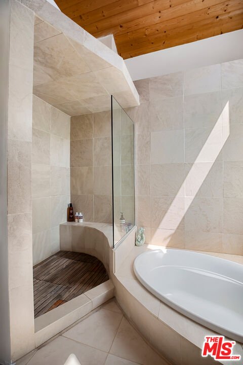 14840 Sunset Boulevard Pacific Palisades, CA 90272 - Photo 19 of 33 a bathroom with a bathtub and shower