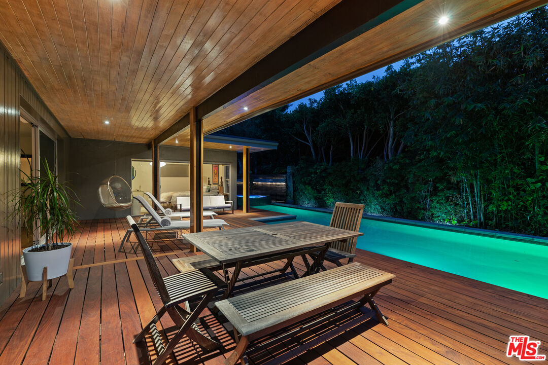 14840 Sunset Boulevard Pacific Palisades, CA 90272 - Photo 29 of 33 a view of a patio with table and chairs with wooden floor and fence