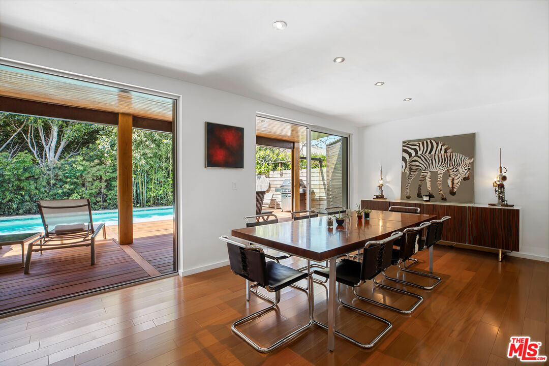 14840 Sunset Boulevard Pacific Palisades, CA 90272 - Photo 7 of 33 a dining room with wooden floor and large windows