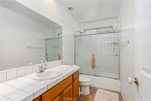 an empty room with a ceiling fan and carpet