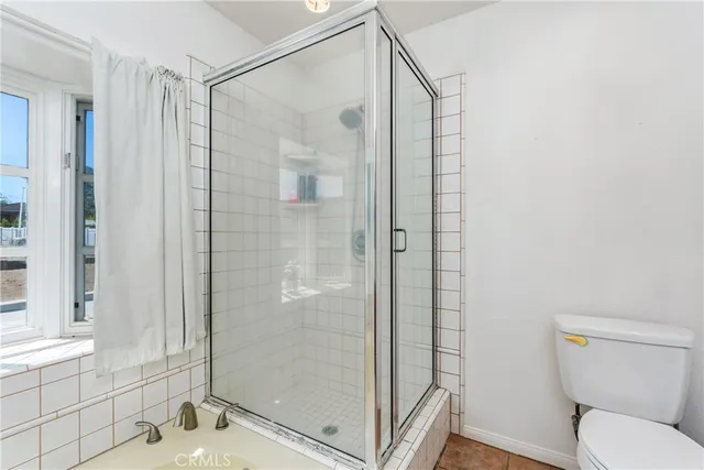 a view of an empty room with window and closet area