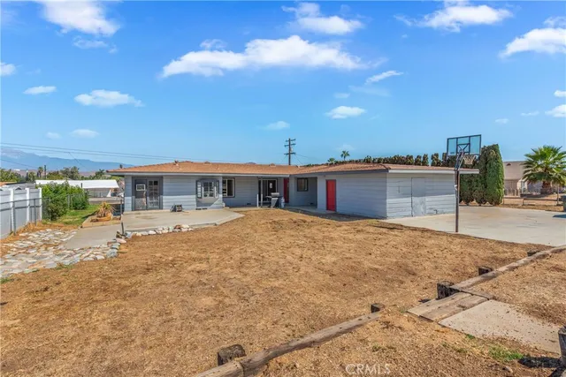a view of a house with pool and sitting area
