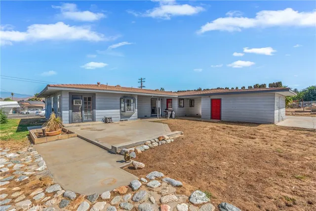 a house view with swimming pool and porch