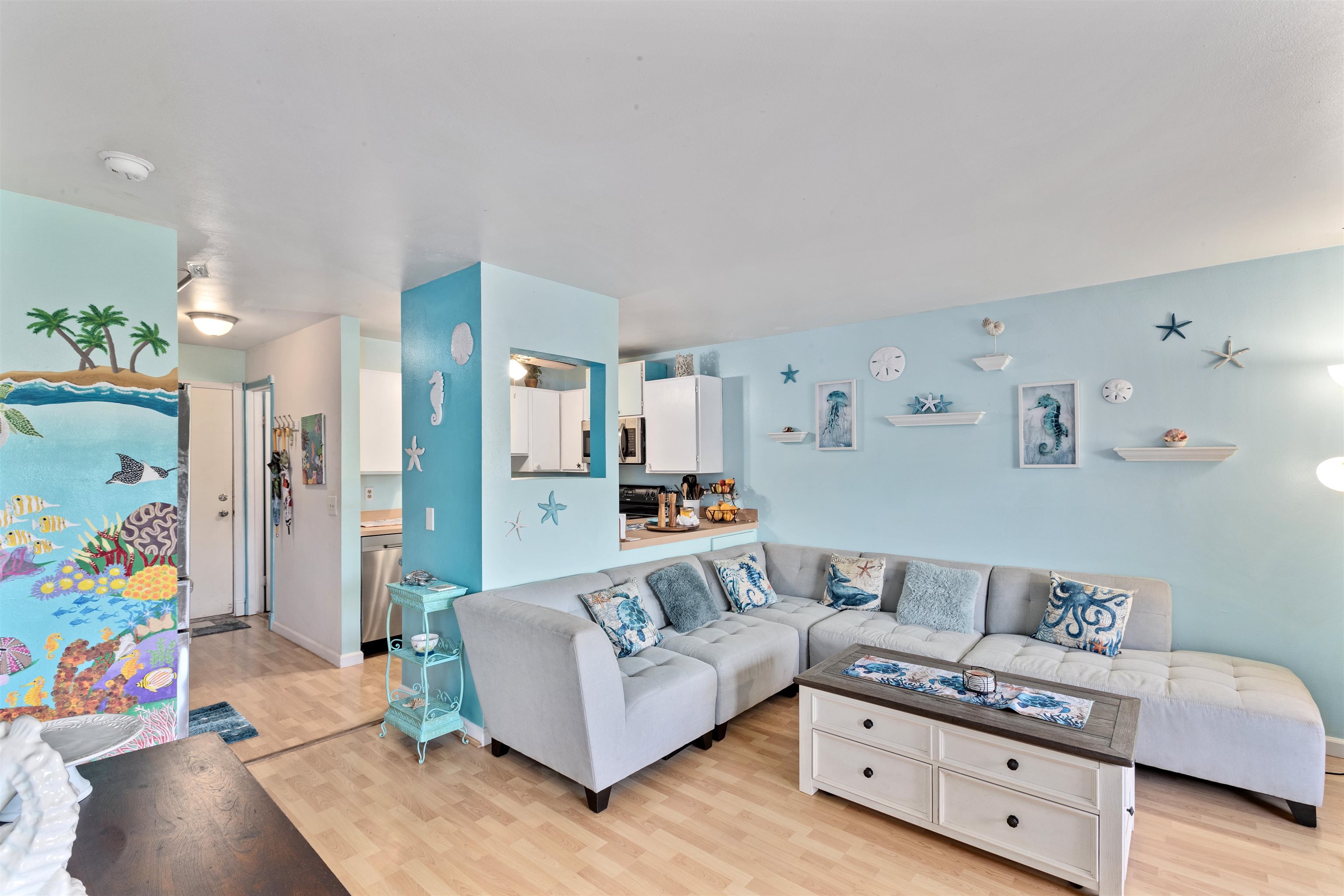 3740 Lower Honoapiilani Road, Unit F306 Lahaina, HI 96761 - Photo 1 of 30 a living room with furniture and a wooden floor