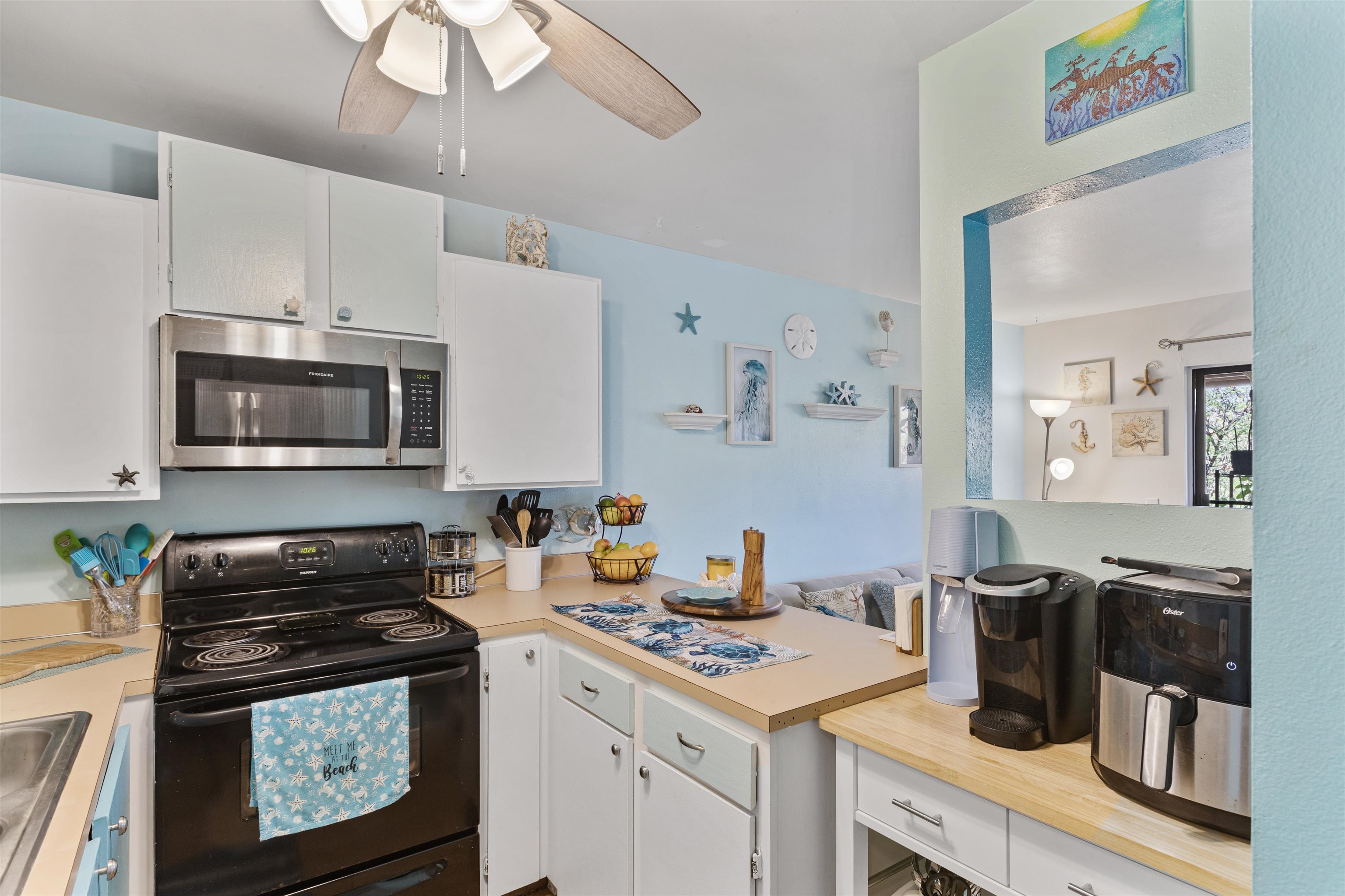 3740 Lower Honoapiilani Road, Unit F306 Lahaina, HI 96761 - Photo 11 of 30 a kitchen with a sink a stove and cabinets