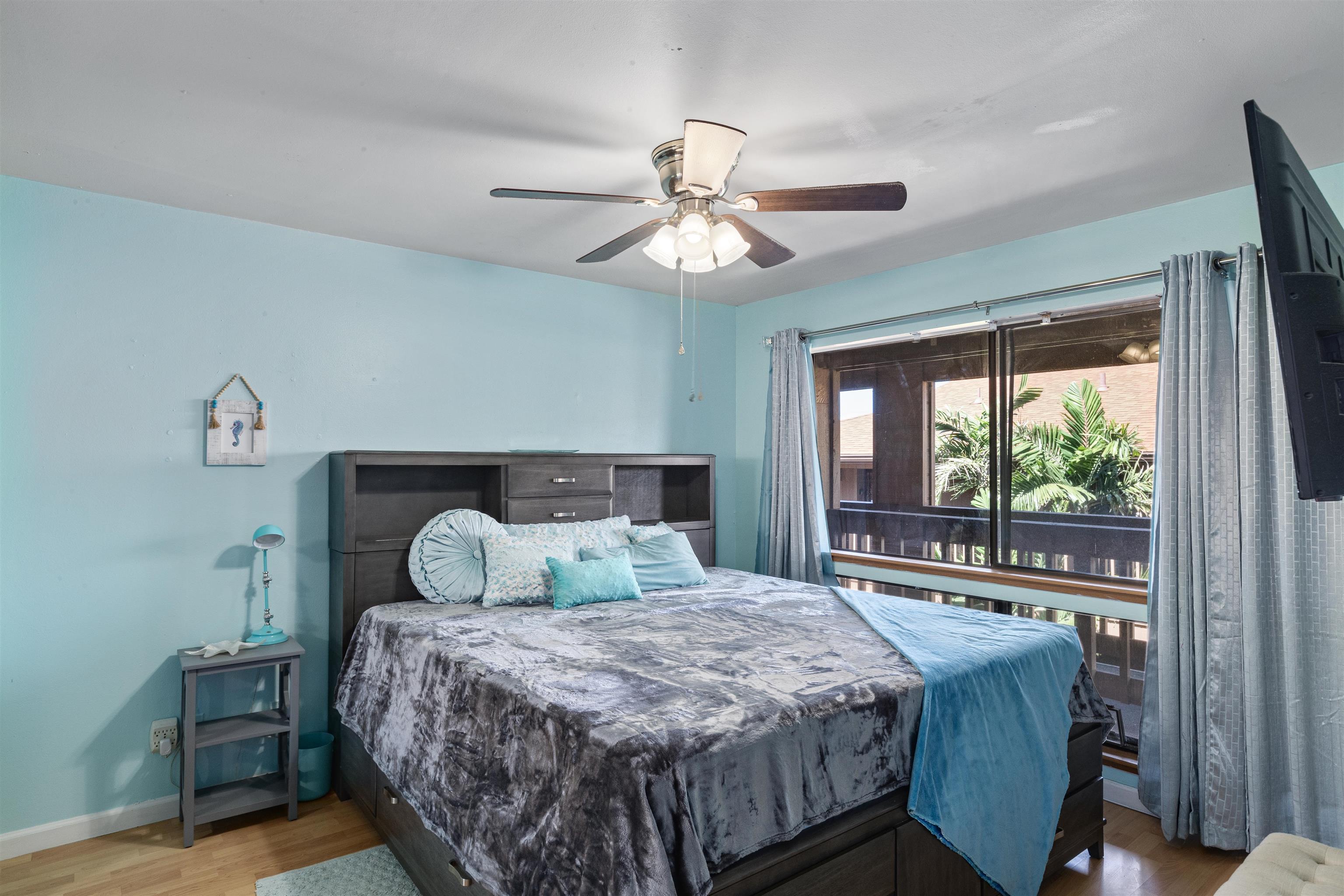 3740 Lower Honoapiilani Road, Unit F306 Lahaina, HI 96761 - Photo 15 of 30 a bedroom with a bed and a chandelier