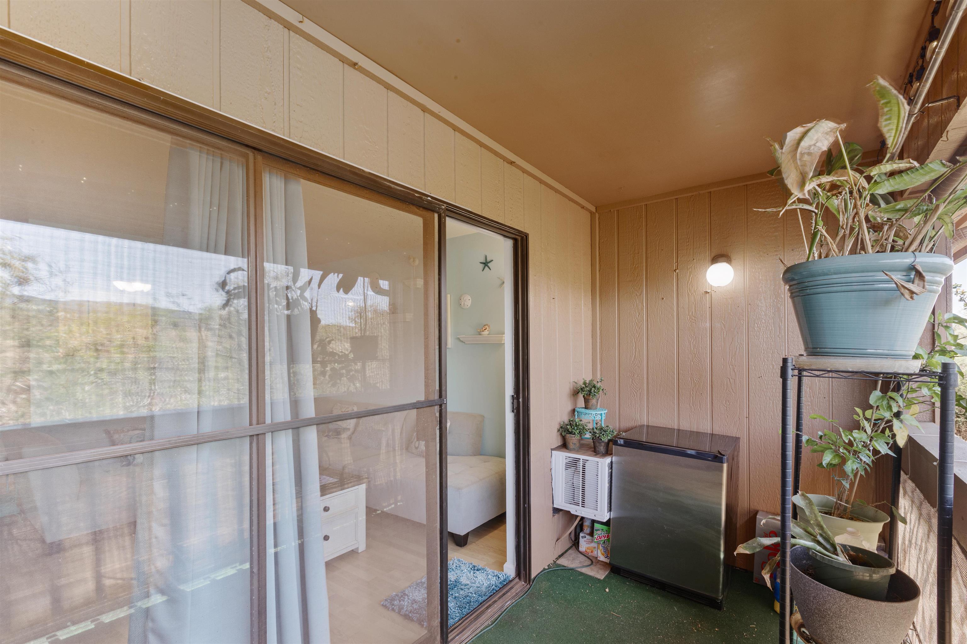 3740 Lower Honoapiilani Road, Unit F306 Lahaina, HI 96761 - Photo 26 of 30 a living room with furniture and a potted plant