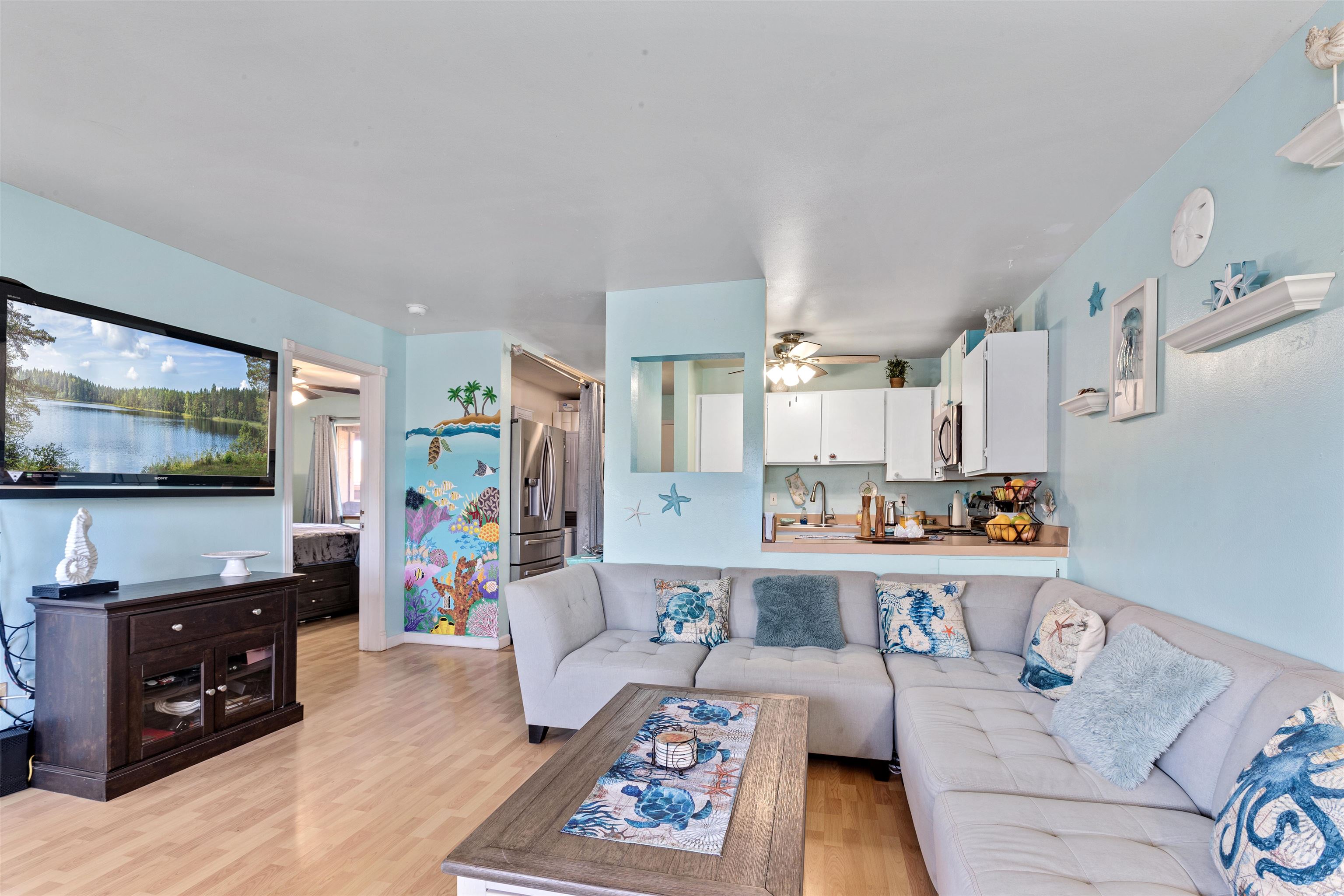 3740 Lower Honoapiilani Road, Unit F306 Lahaina, HI 96761 - Photo 4 of 30 a living room with furniture and a flat screen tv