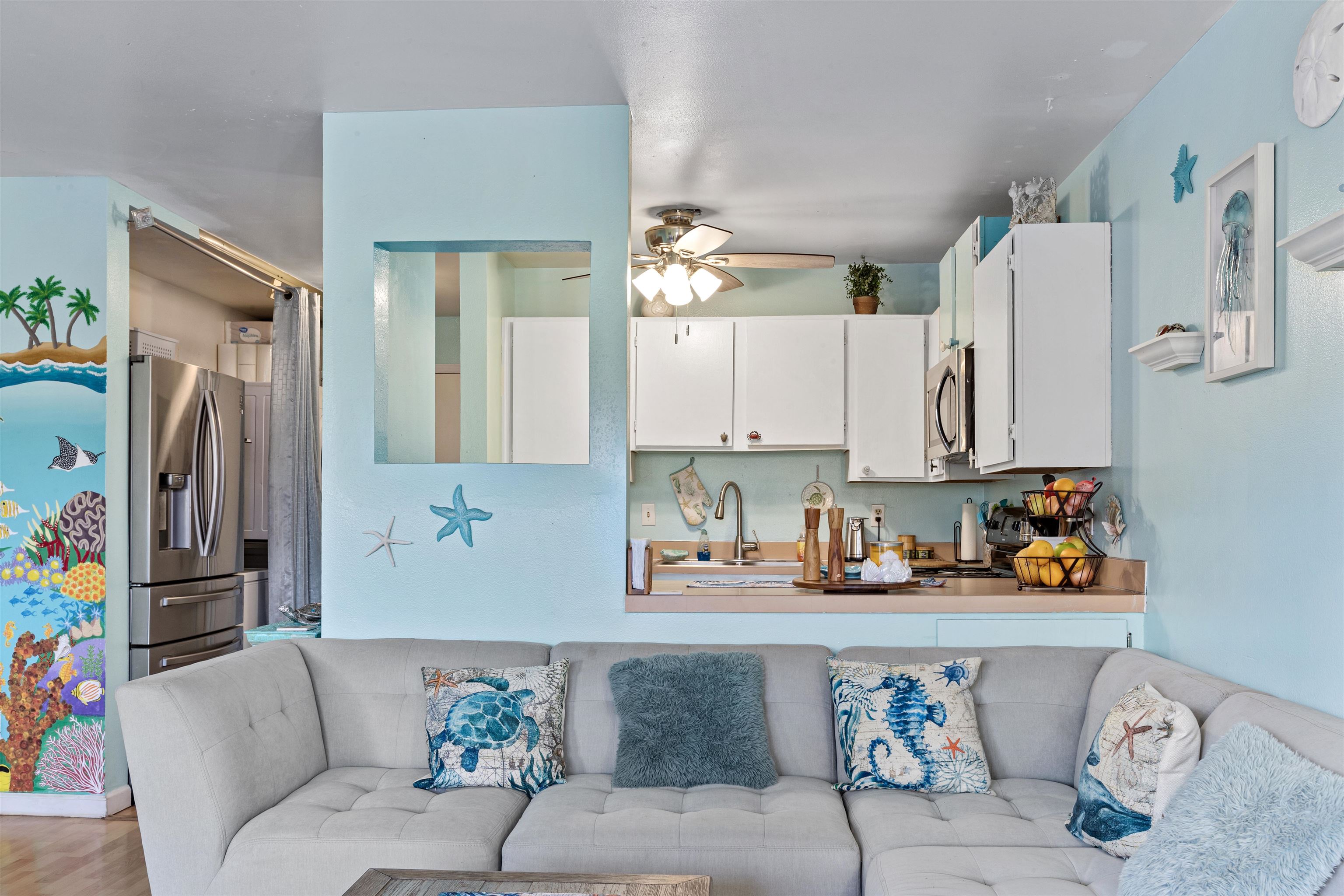 3740 Lower Honoapiilani Road, Unit F306 Lahaina, HI 96761 - Photo 5 of 30 a living room with furniture and a chandelier