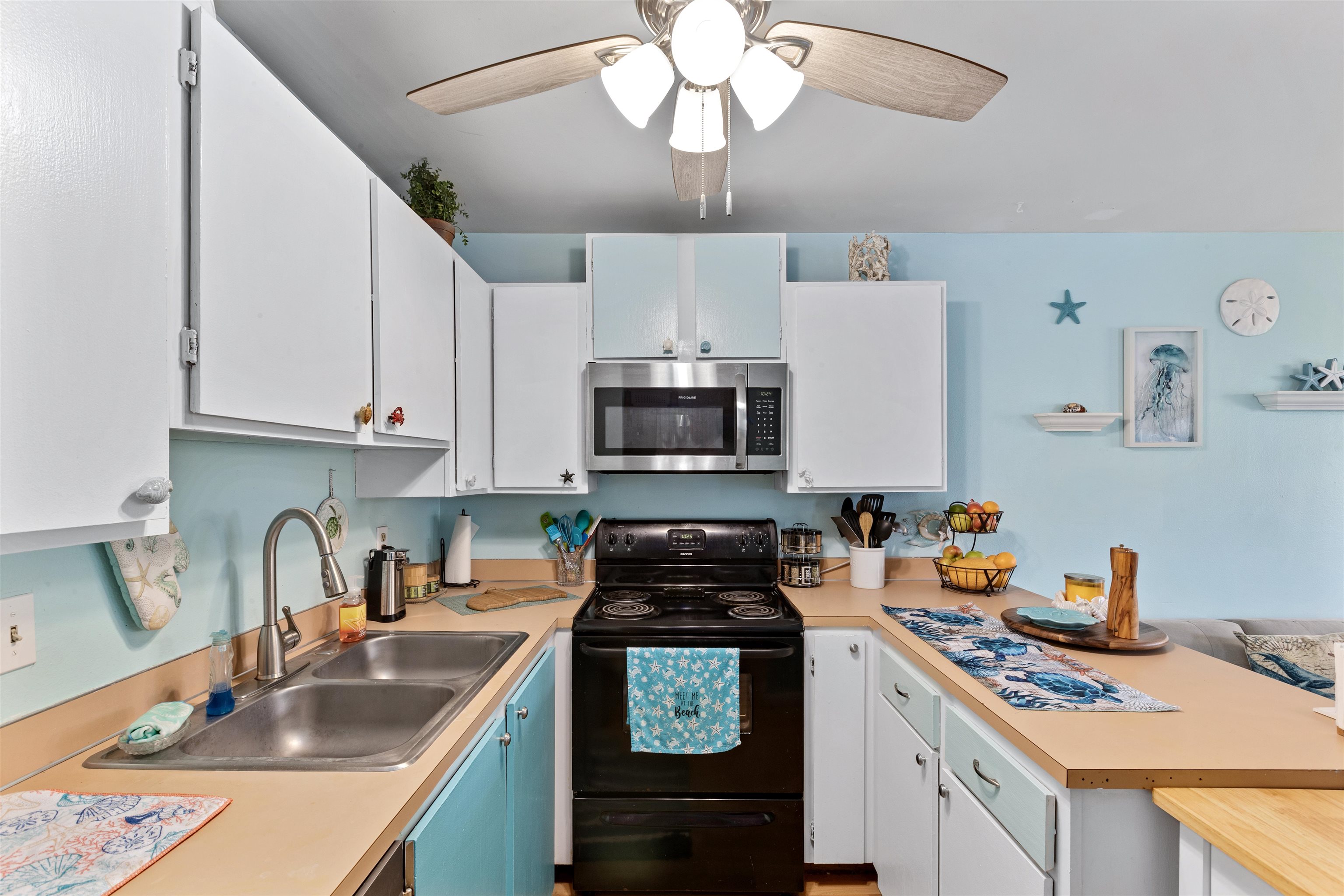 3740 Lower Honoapiilani Road, Unit F306 Lahaina, HI 96761 - Photo 9 of 30 a kitchen with stainless steel appliances granite countertop a sink stove and cabinets