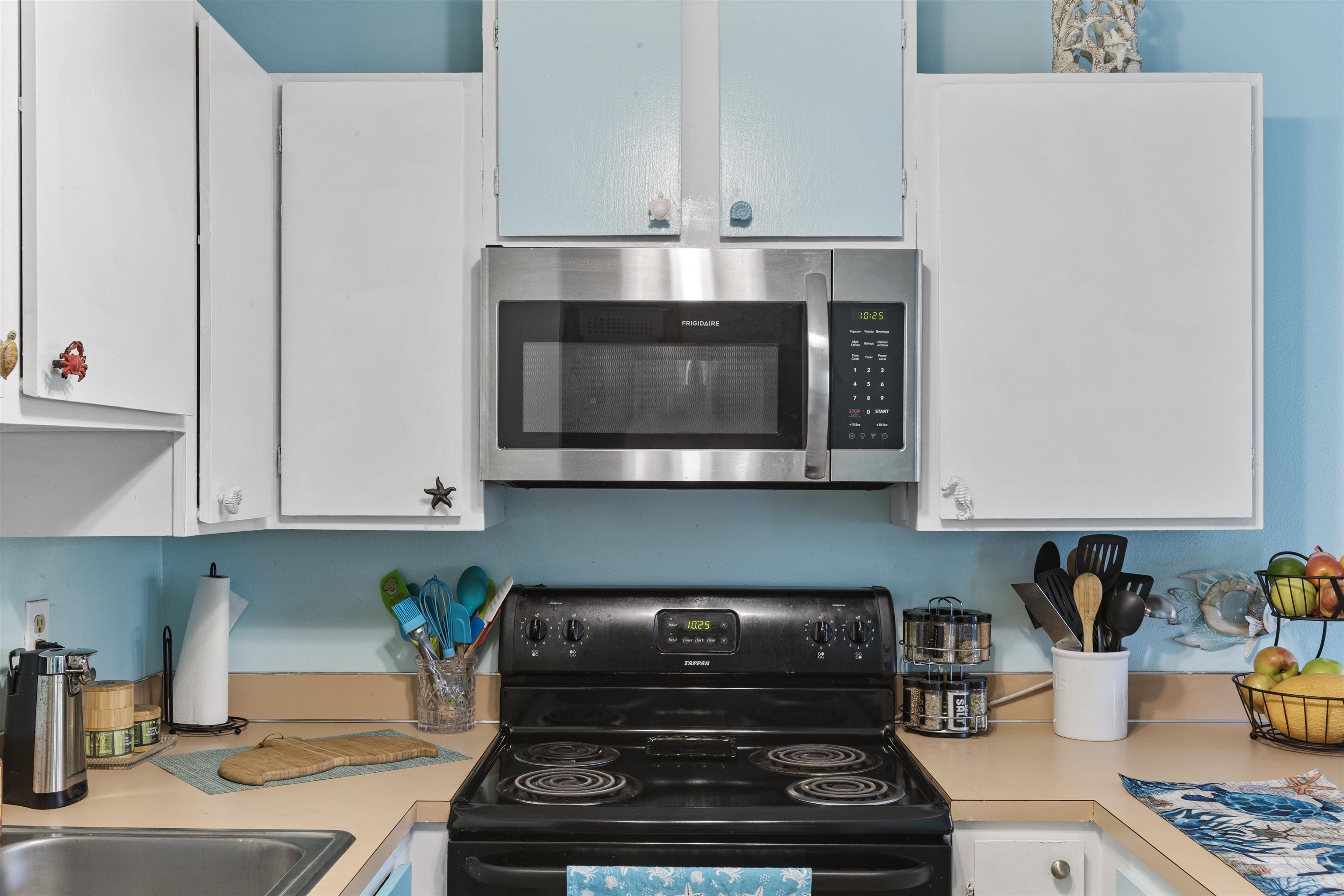 3740 Lower Honoapiilani Road, Unit F306 Lahaina, HI 96761 - Photo 10 of 30 a kitchen with a stove and cabinets