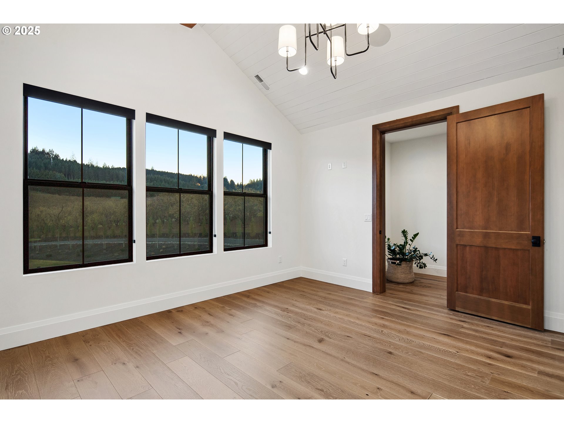 48493 Northwest Hillside Road Forest Grove, OR 97116 - Photo 39 of 48 a view of an empty room with wooden floor and a window