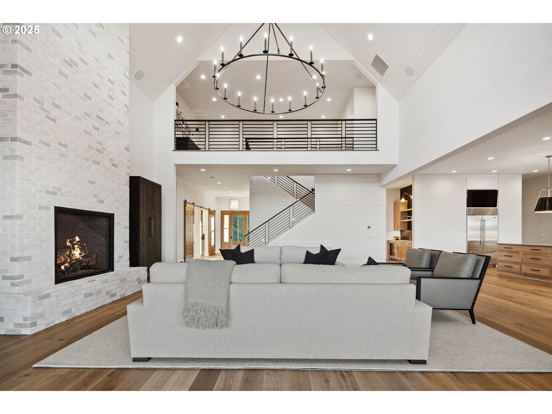 48493 Northwest Hillside Road Forest Grove, OR 97116 - Photo 6 of 48 a living room with furniture a chandelier and a fireplace