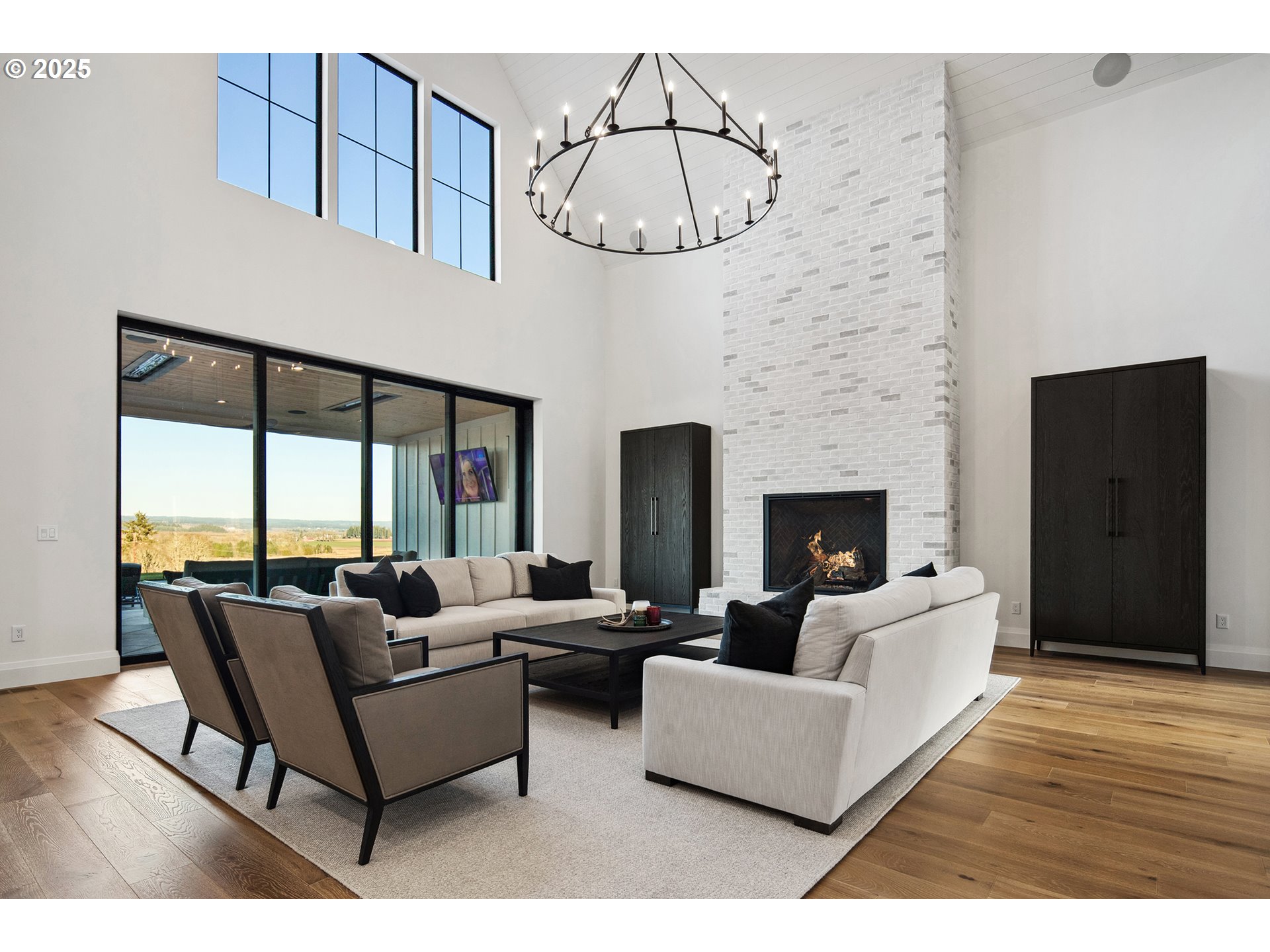 48493 Northwest Hillside Road Forest Grove, OR 97116 - Photo 7 of 48 a living room with furniture a fireplace and a floor to ceiling window