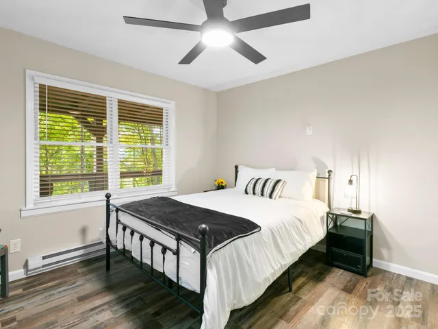 a bedroom with a bed and a large window