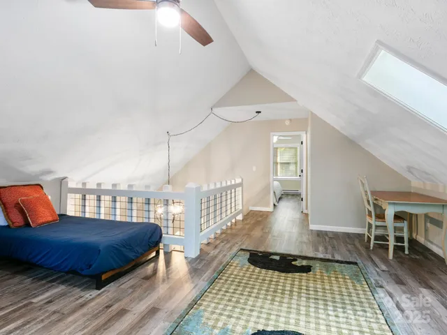 a living room with furniture a rug and wooden floor