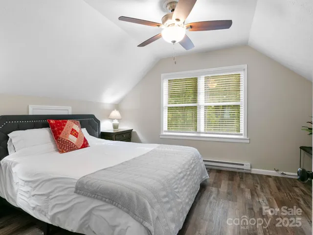 a bedroom with a large bed and a large window