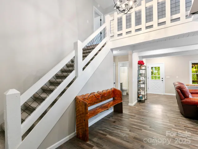 a view of an entryway with wooden floor and livingroom