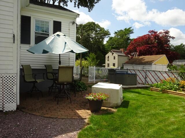 13 Old Salt Works Road Buzzards Bay, MA 02532 - Photo 37 of 49 a front view of a house with garden and chairs