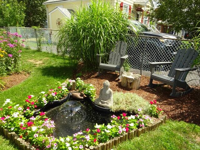 13 Old Salt Works Road Buzzards Bay, MA 02532 - Photo 4 of 49 a garden with flowers and wooden fence
