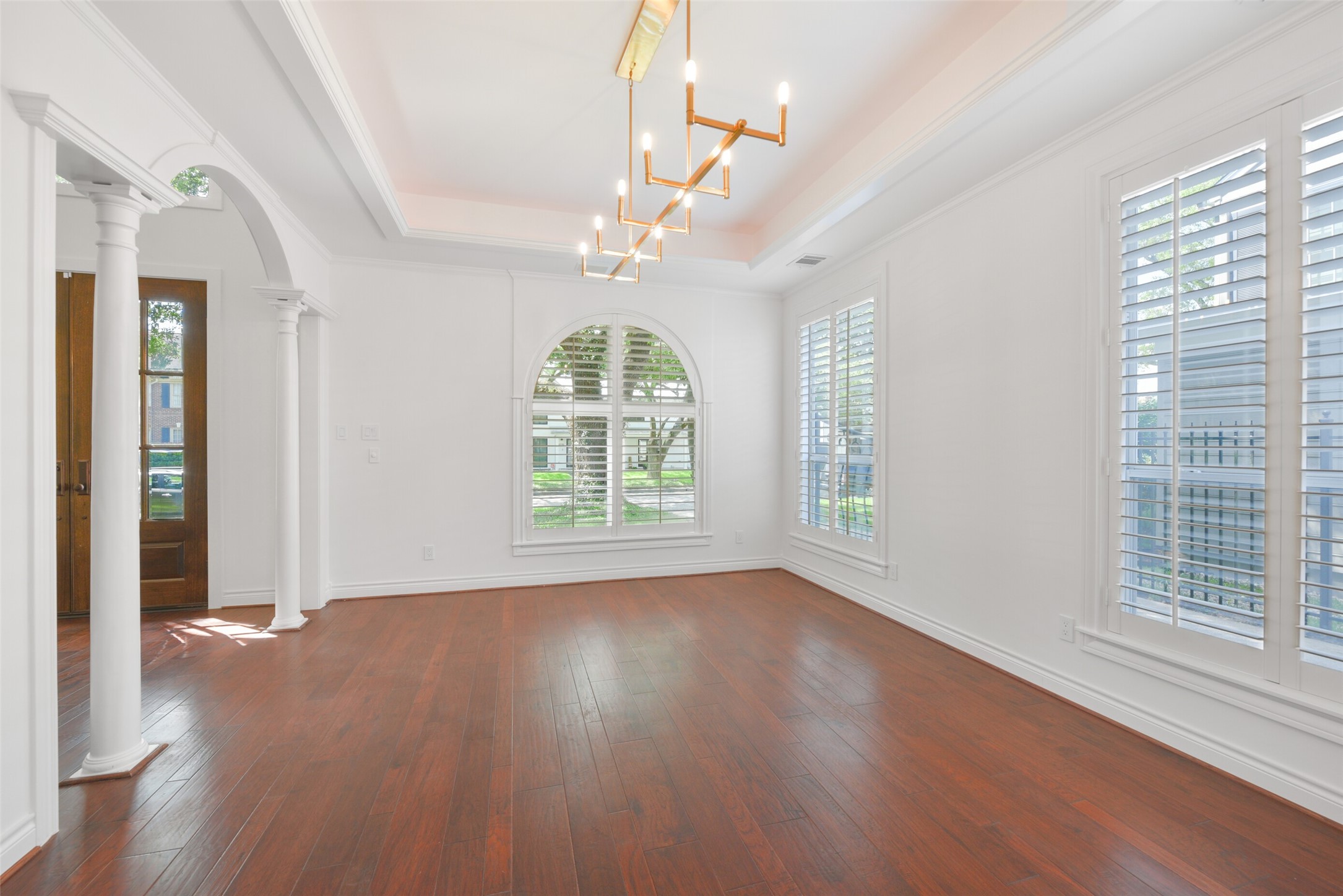 3724 Wroxton Road Houston, TX 77005 - Photo 8 of 40 The oversized dining room with gorgeous light feature, large, shuttered windows overlooking the front and side of the property, and tray ceiling for dramatic effect.