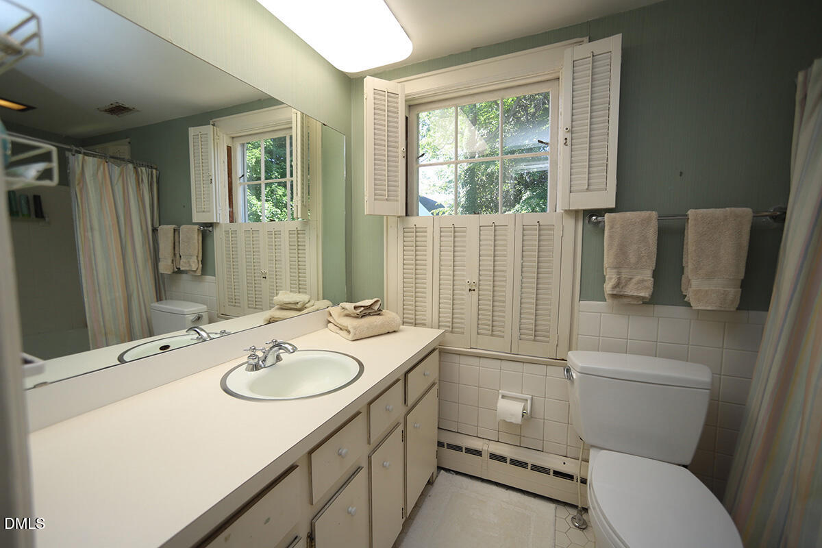 2601 York Road Raleigh, NC 27608 - Photo 14 of 24 a bathroom with a sink toilet and shower