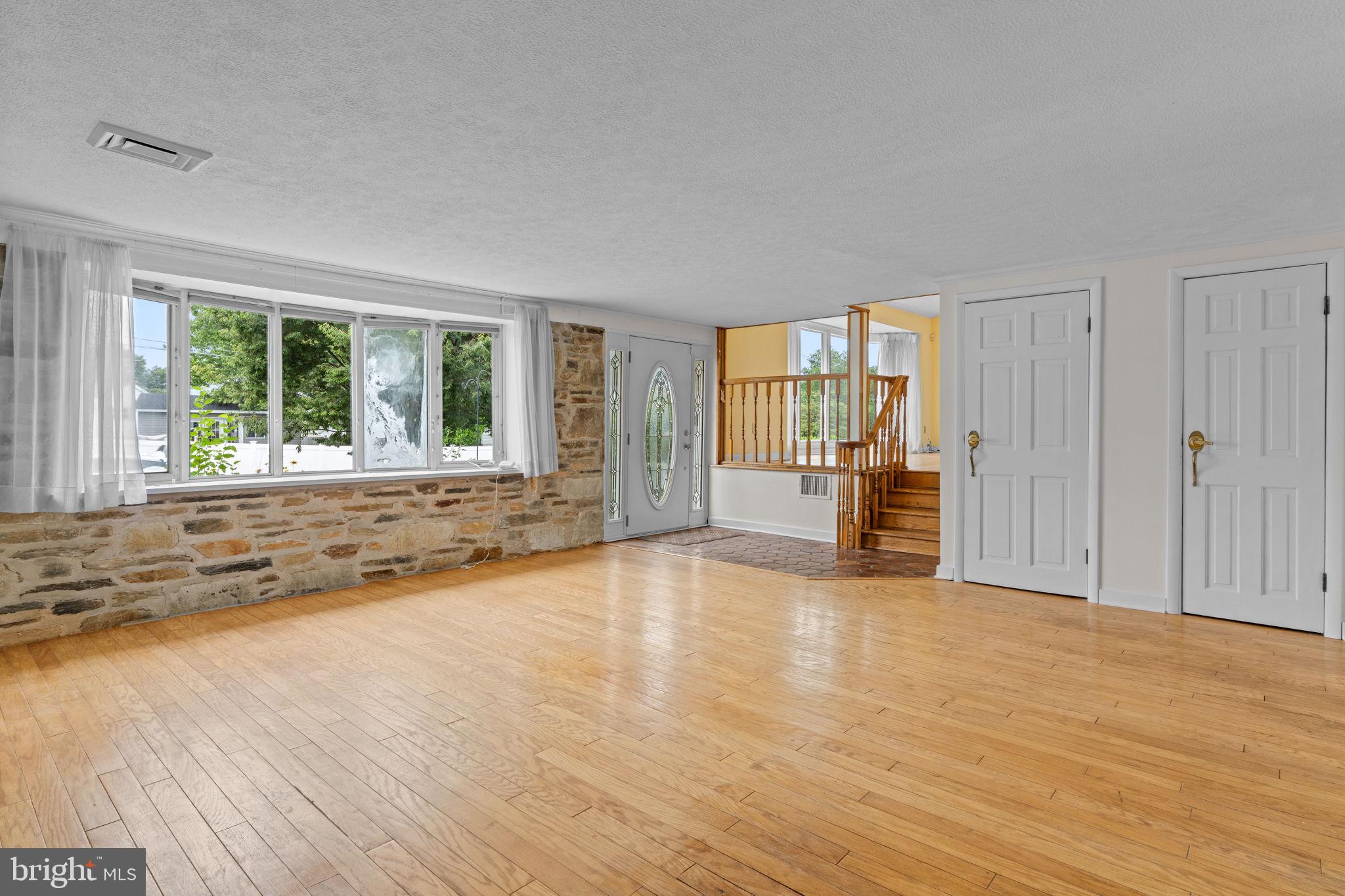 3817 Dorchester Road Philadelphia, PA 19154 - Photo 4 of 32 a view of an empty room with a window and wooden floor