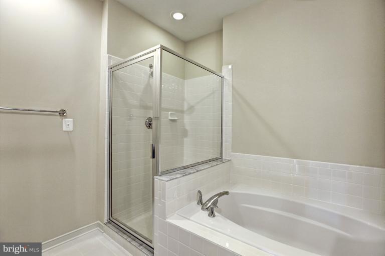 915 4th Street Southeast Washington, DC 20003 - Photo 13 of 24 a bathroom with a bathtub and a shower