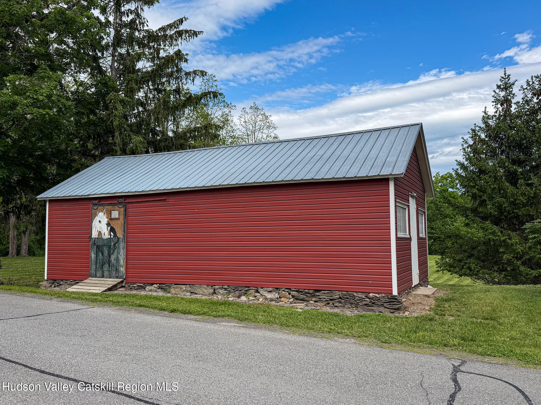221 Camp Medusa Road Rensselaerville, NY 12120 - Photo 42 of 57 a front view of a house with a yard and garage