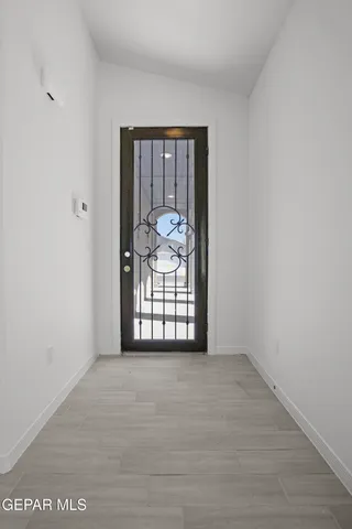 an empty room with fan and windows