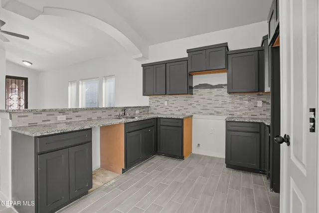 a view of a big room with wooden floor and a ceiling fan